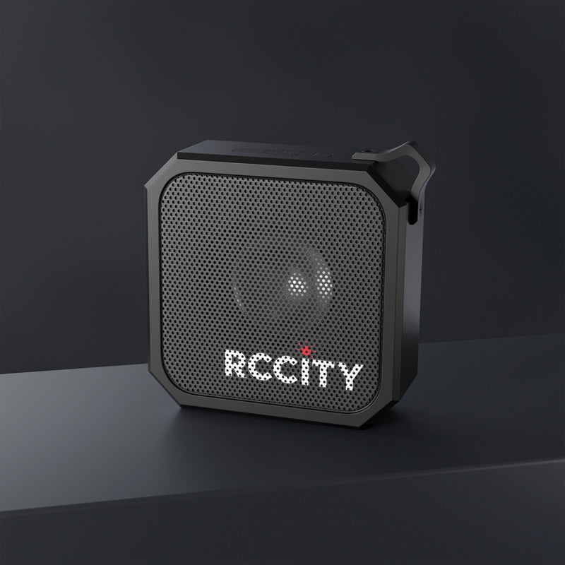 Black portable speaker with 'RCCCity' branding on a dark background