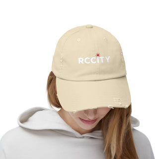 Beige cap with 'RCCITY' logo worn by a person 