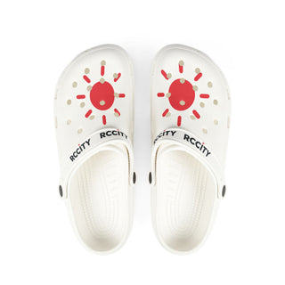 White sandals with red sun design